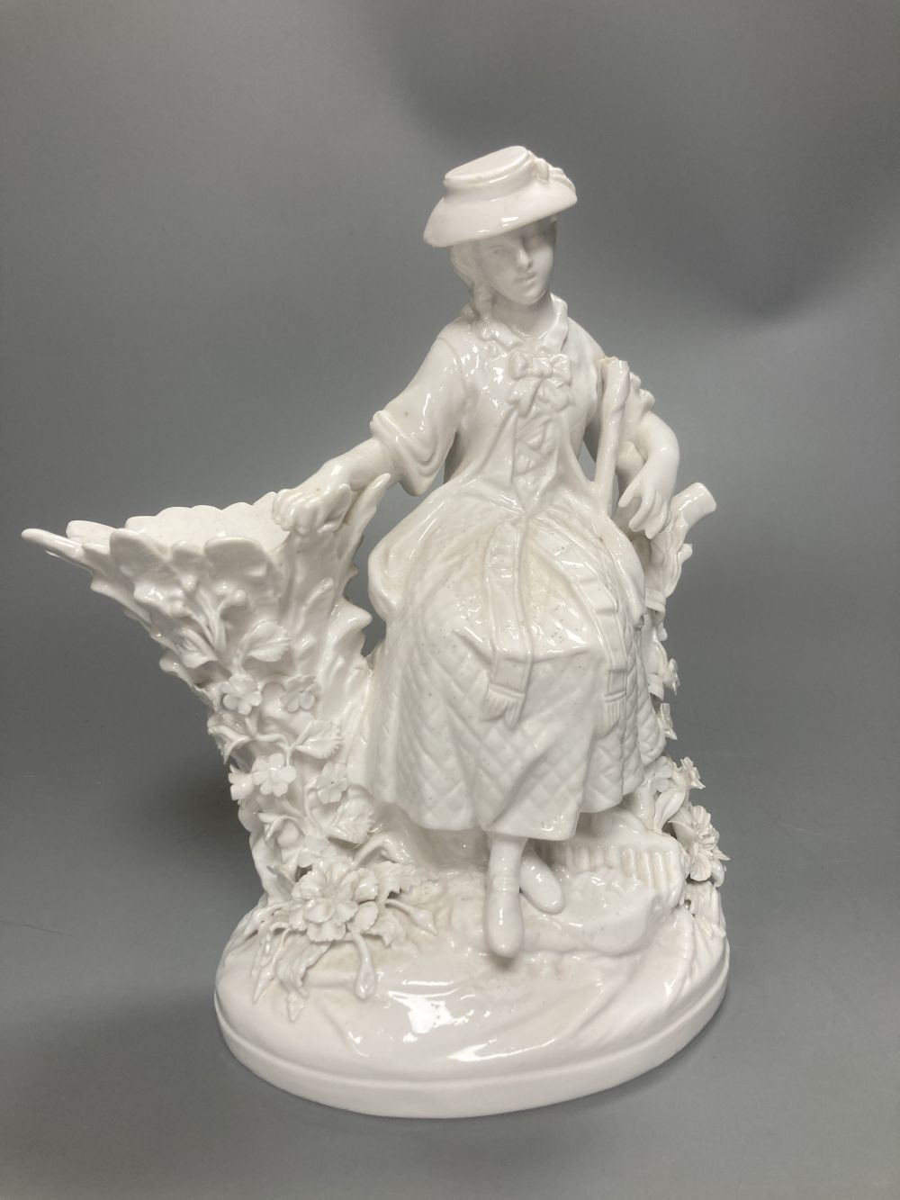 A pair of John Bevington bone china figures, gardener and female companion, 21.5cm
